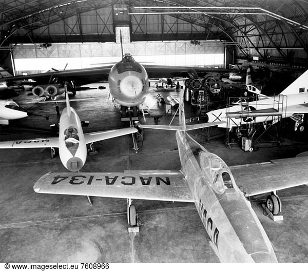 In the center foreground of this 1953 hanger photo is the YF_84A NACA 134/Air Force 45_59490 used for vortex generator research. It arrived on November 28  1949  and departed on April 21  1954. Beside it is the third D_558_1 aircraft NACA 142/Navy 37972. This aircraft was used for a total of 78 transonic research flights from April 1949 to June 1954. It replaced the second D_558_1  lost in the crash which killed Howard Lilly. Just visible on the left edge is the nose of the first D_558_2 NACA 143/Navy 37973. Douglas turned the aircraft over to NACA on August 31  1951  after the contractor had completed its initial test flights. NACA only made a single flight with the aircraft  on September 17  1956  before the program was cancelled. In the center of the photo is the B_47A NACA 150/Air Force 49_1900. The B_47 jet bomber  with its thin  swept_back wings  and six podded engines  represented the state of the art in aircraft design in the early 1950s. The aircraft undertook a number of research activities between May 1953 and its 78th and final research flight on November 22  1957. The tests showed that the aircraft had a buffeting problem at speeds above Mach 0.8. Among the pilots who flew the B_47 were later X_15 pilots Joe Walker  A. Scott Crossfield  John B. McKay  and Neil A. Armstrong. On the right side of the B_47 is NACA´s X_1 Air Force 46_063. The second XS_1 aircraft built  it was fitted with a thicker wing than that on the first aircraft  which had exceeded Mach 1 on October 14  1947. Flight research by NACA pilots indicated that this thicker wing produced 30 percent more drag at transonic speeds compared to the thinner wing on the first X_1. After a final flight on October 23  1951  the aircraft was grounded due to the possibility of fatigue failure of the nitrogen spheres used to pressurize the fuel tanks. At the time of this photo  in 1953  the aircraft was in storage. In 1955  the aircraft was extensively modified  becoming the X_1E. In front of the X_1 is the XF_92A Air Force 46_682. Unlike the X_1 and D_558 aircraft  the XF_92A was not designed as a research aircraft  but as the prototype of a delta_wing fighter. While the effort was unsuccessful  the XF_92A offered the chance to test a delta wing aircraft. A brief series of 25 flights were made using the aircraft in 1953. These showed the aircraft had violent pitch_up tendencies during turns. Despite the problems  the XF_92A contributed to later delta wing aircraft  like the F_102  F_106  and B_58. Behind the B_47  in the back of the hangar  are four other aircraft. From left to right  they are the second X_4 Air Force 46_677 research aircraft. It was operated by the NACA from May 8  1950  to March 22  1954  when it left the High_Speed Flight Research Station for the U.S. Air Force Museum. It was designed to test the use of swept wings but no horizontal stabilizers. This proved to have poor transonic stability. Next to it is the ETF_51D Mustang NACA 148/Air Force 44_84958 used for low_speed chase missions  as well as support and liaison flights. On the right side of the B_47 is the first D_558_1. Originally given the Navy number 37970  it was flown as part of the Douglas contractor program. When this was completed  the aircraft was turned over to the NACA on April 11  1949. Although the aircraft was designation NACA 140  it was never flown again. Instead  it was used to provide spare parts to keep the third D_558_1 in operation. In this photo the aircraft is partially disassembled. The final aircraft is the first X_5 Air Force 50_1838. This was a research aircraft used to test the concept of pivoting wings which could change their sweep angle in flight. The results were mixed  the X_5 had vicious stall behavior due to the poor position of the tail and stabilizers. The mechanism used by the variable_sweep wing was also complex  which limited its usefulness. Despite these problems  the X_5´s primary advantage was that it was equivalent to a whole family of research aircraft. It could provide transonic data at sweep angles up to 60 degrees__the same as the delta wing XF_92A.