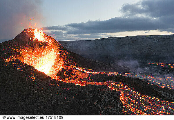 incandescent flowing volcanic lava and caldera in long expo