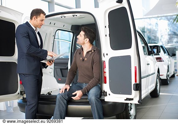 Indecisive customer and salesman in car dealership