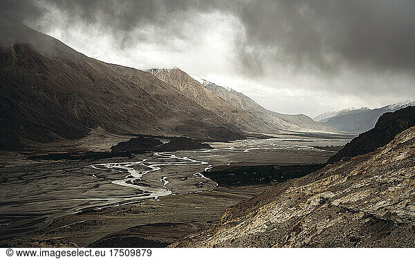 India  Ladakh  Clouds over narrow stream flowing across valley in Himalayas