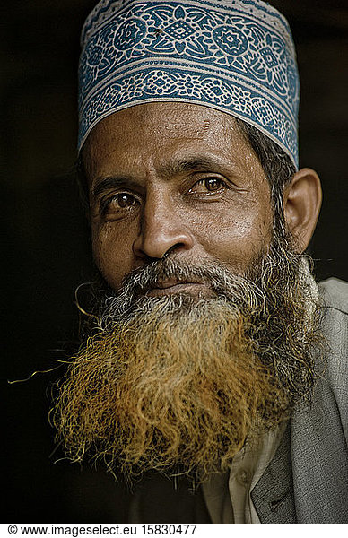 Indian man with dyed beard wearing a Taqiyah  a muslim cap