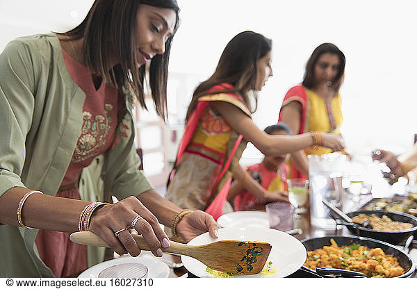 Indian women in saris serving food