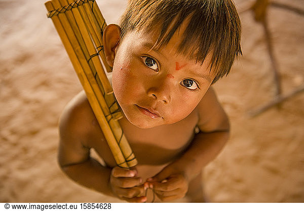 Indigenous kid hold his typical flute at Dessana Village