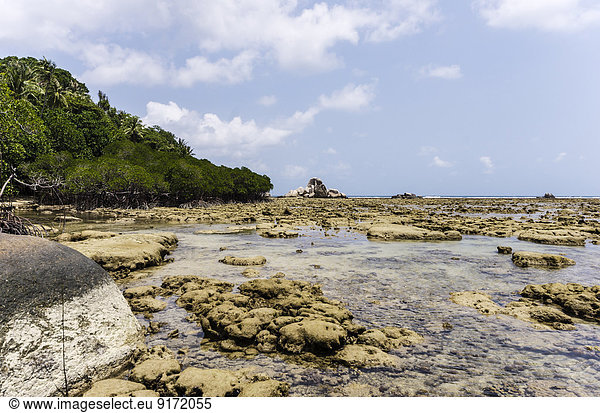 Indonesia,  Riau Islands,  Bintan,  Nikoi Island,  Beach with granite blocks