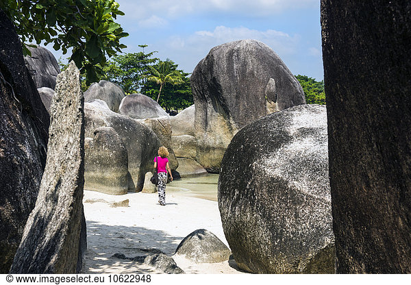 Indonesia  Belitung  Tanjung Tinggi Beach  granitic rocks  female walker at beach