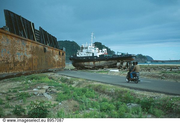 INDONESIA Tsunami Aceh Province. Two large metal ships dumped on middle of a road outside Banda Aceh town by wave..
