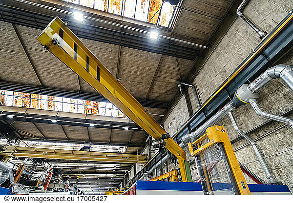 Industrial crane in illuminated factory