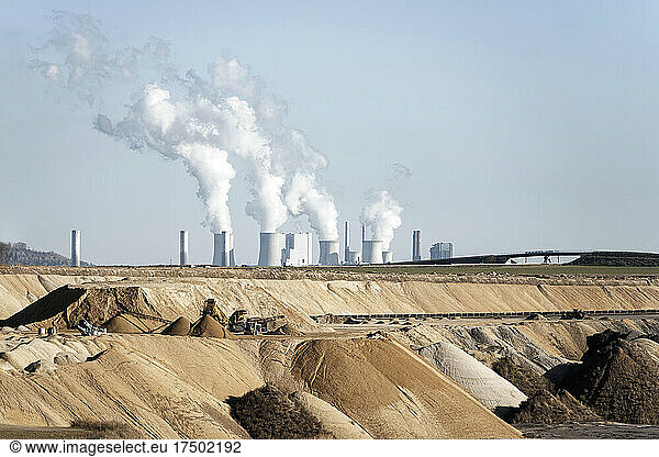 Industrial smoke stacks emitting pollution at Garzweiler Surface Mine  North Rhine-Westphalia  Germany