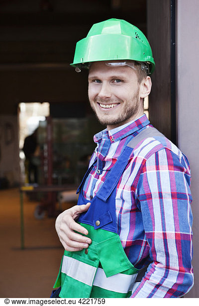 Industrial worker in green helmet