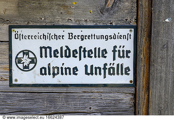 Information sign hanging on wooden wall