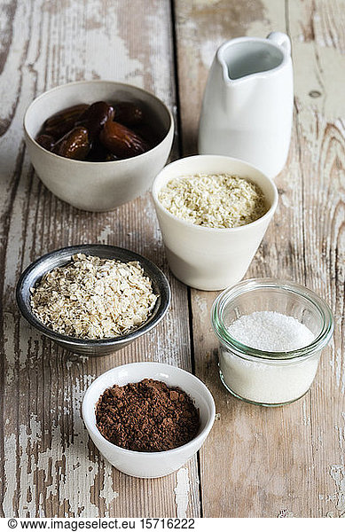 Ingredients for making protein balls (coconut oil  dates  millet flakes  oat flakes  grated coconut and cocoa powder)