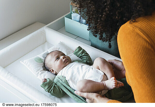 Innocent son lying in crib at home