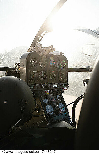 Inside cockpit of a military helicopter with sunlight