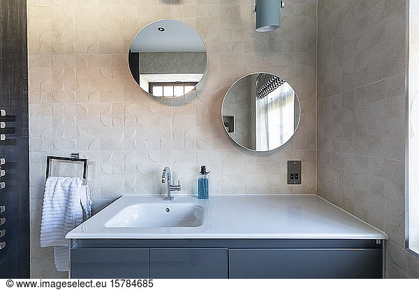 Interior of a bathroom in a luxurious property  mirrors over the basin  London  UK