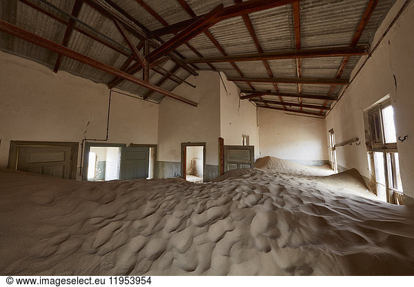 Interior of an abandoned building full of sand.