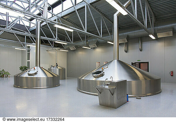 Interior of brewery  large steel storage tanks for brewing beer.