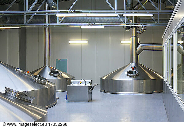 Interior of brewery  large steel storage tanks for brewing beer.