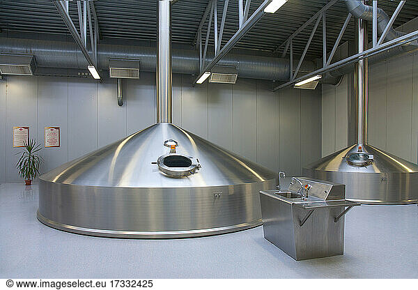 Interior of brewery  large steel storage tanks for brewing beer.