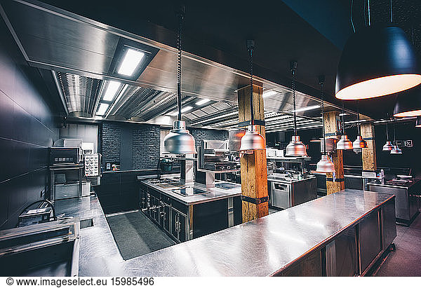 Interior of illuminated commercial kitchen in restaurant