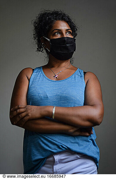 Interior portrait of woman wearing a face mask
