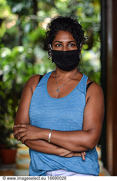 Interior portrait of woman wearing a face mask
