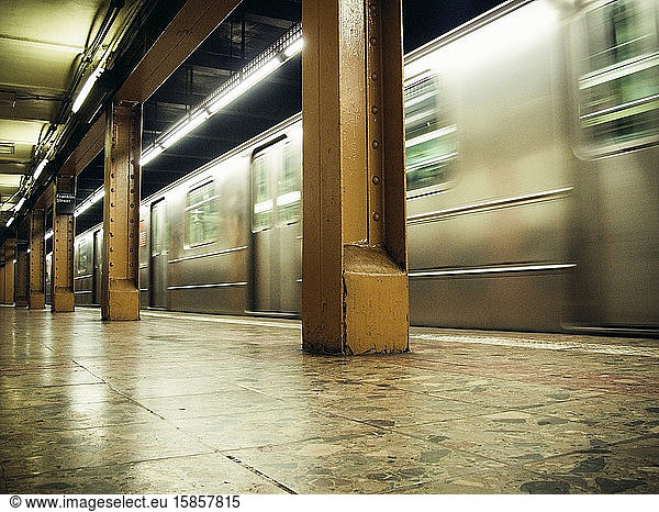 Interior view of subway moving through station in NYC