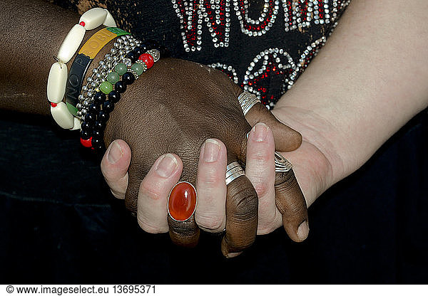 Interracial  gay married couple holding hands (MR)