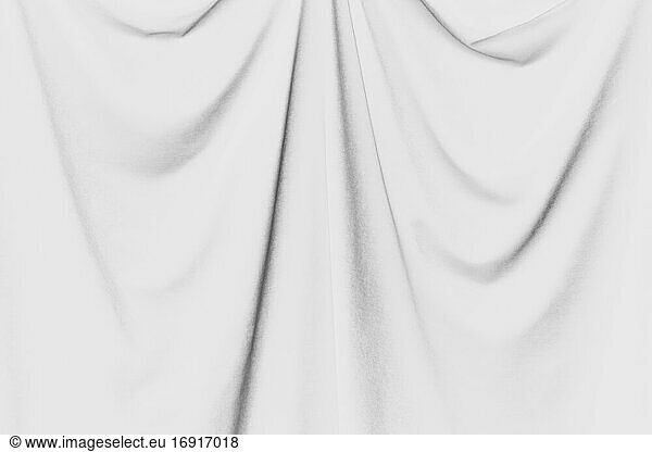 Inverted black and white image of draped velvet curtain