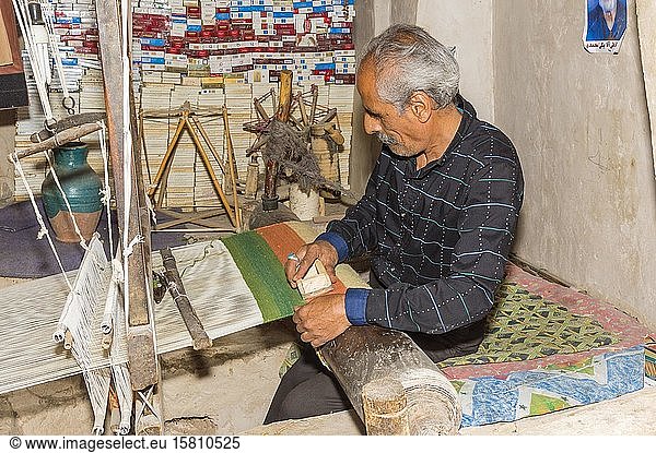 Iranischer Mann bei der Arbeit an einem Webstuhl  Na?in  Provinz Isfahan  Iran  Asien
