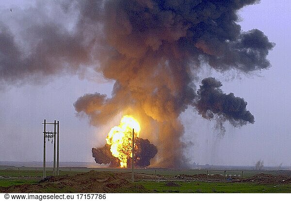 IRAQ Al Fathah -- 05 Feb 2004 -- Explosions rock the ground here as Army engineers and Air Force explosive ordnance disposal workers detonate a weapons cache. An estimated 2 million net pounds of explosives were left at the air field by the old regime  making it the largest single weapons cache uncovered by the coalition to date. Workers are destroying an average of 100 000 pounds of weapons per day. US Air Force photo (Released) -- Picture by Jeffrey A Wolfe / Lightroom Photos / USAF.