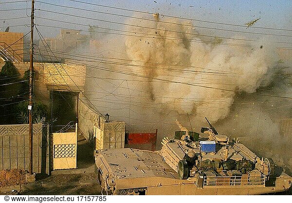 IRAQ Fallujah -- 10. Dezember 2004 -- Ein M1A1 Abrams-Panzer des US Marine Corps feuert in ein Gebäude  aus dem Marines während eines Feuergefechts in Fallujah  Irak  zur Unterstützung der Operation Al Fajr (New Dawn) am 10. Dezember 2004 beschossen wurden. Al Fajr ist eine Offensivoperation zur Vernichtung feindlicher Kräfte in der Stadt Fallujah zur Unterstützung der laufenden Sicherheits- und Stabilisierungsoperationen in der irakischen Provinz Al Anbar durch Einheiten der 1st Marine Division. Der M1A1-Panzer ist dem 2. Panzerbattalion zugeordnet. Die Schlacht um Fallujah erwies sich als eines der schwersten Gefechte zwischen irakischen Aufständischen und US-Truppen. USMC-Foto (freigegeben) -- Bild von James J Vooris / Lightroom Photos / USMC.