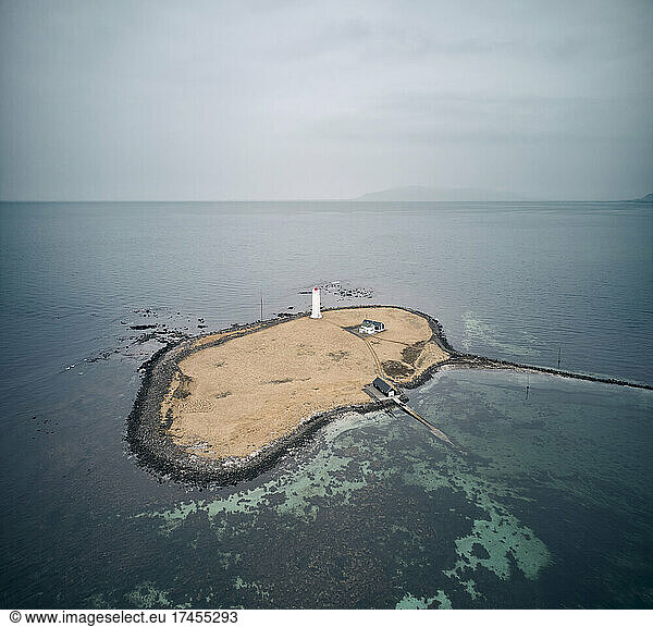 Island with lighthouse in sea