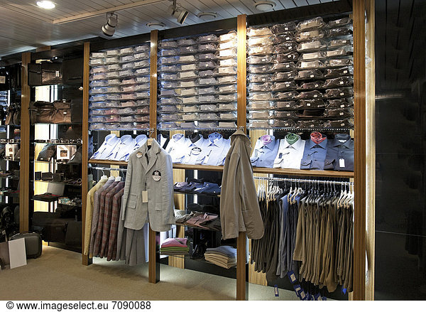 Italian men's fashion shop in Tallinn airport. Retail outlet. Display of shirts and suits.