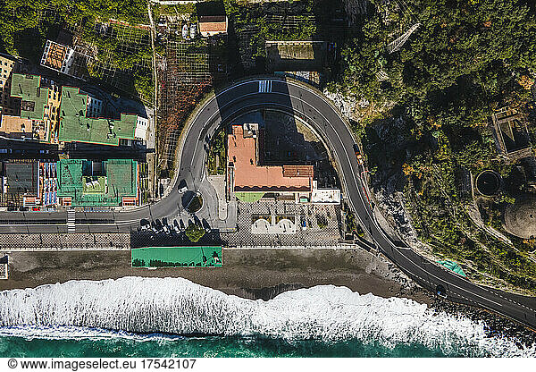 Italy,  Province of Salerno,  Amalfi,  Drone view of asphalt road stretching through town on Amalfi Coast