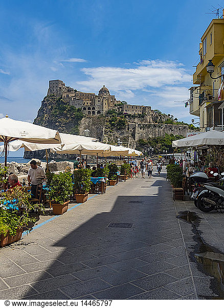 Italy  Campania  Naples  Gulf of Naples  Ischia Island  Aragonese Castle on rock island  restaurant in the foreground