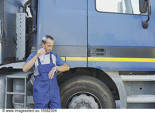 Italy  Chiajna  Truck-Driver standing by truck