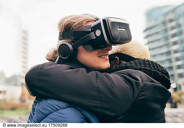 Italy  Couple withVRgoggles hugging in city