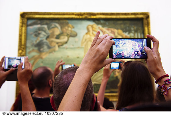 Italy  Florence  tourists taking pictures of 'The Birth of Venus' by Sandro Botticelli in Galleria degli Uffizi