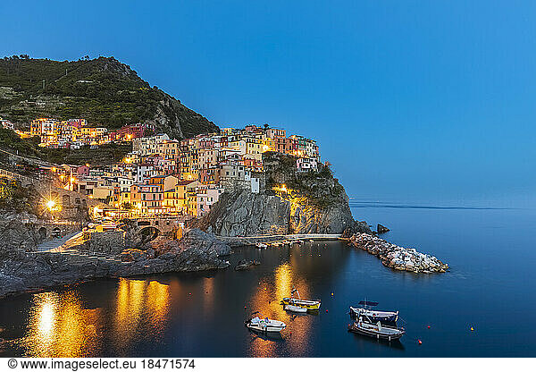 Italy  La Spezia  Manarola  View of coastal village in Cinque Terre at dusk