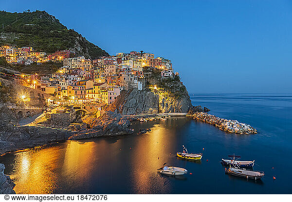 Italy  La Spezia  Manarola  View of coastal village in Cinque Terre at dusk