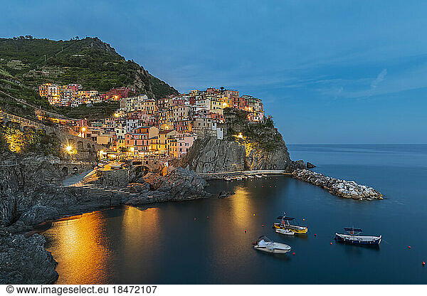 Italy  La Spezia  Manarola  View of coastal village in Cinque Terre at dusk
