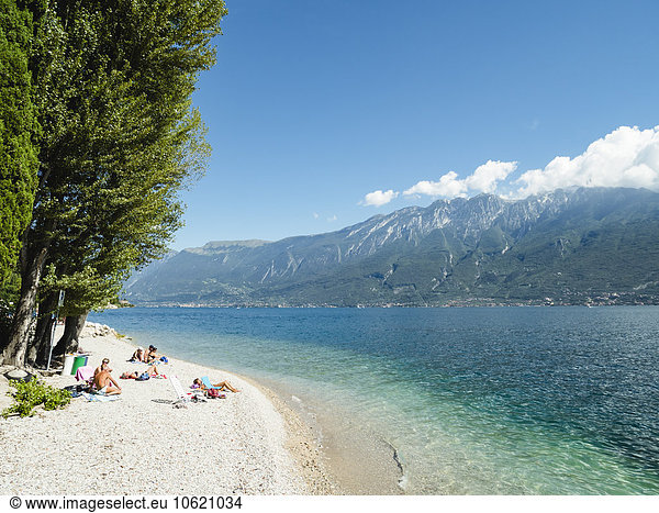 Italy  Lake Garda  People sunbathing at beach near Porto di Tignale