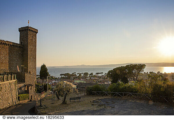 Italy  Lazio  Bolsena  Tower of Rocca Monaldeschi della Cervara castle and surrounding town at sunset