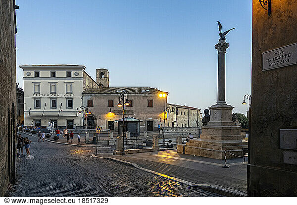 Italy  Lazio  Tarquinia  Piazza Cavour at dusk with Monumento a Giuseppe Mazzini and Teatro Comunale Rossella Falk in background