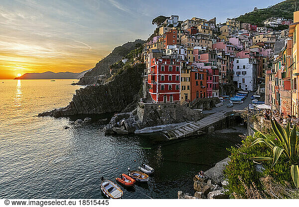 Italy  Liguria  Riomaggiore  Edge of coastal village along Cinque Terre at sunset
