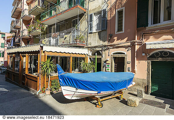 Italy  Liguria  Riomaggiore  Wrapped boat standing on street of coastal town along Cinque Terre