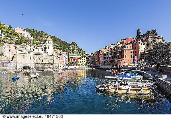 Italy  Liguria  Vernazza  Edge of coastal town along Cinque Terre with boats moored in foreground