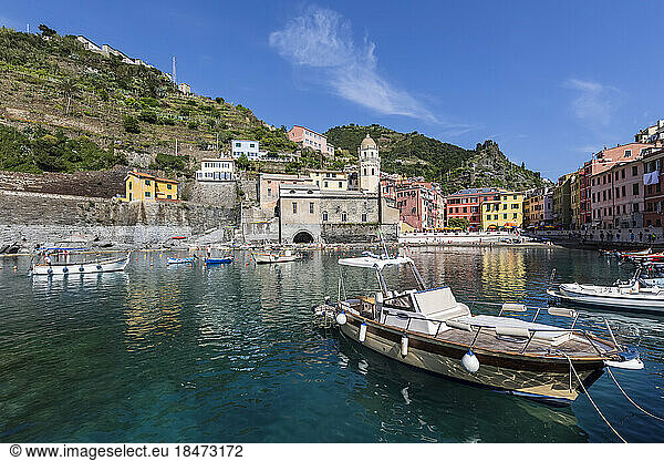 Italy  Liguria  Vernazza  Edge of coastal town along Cinque Terre with boats moored in foreground