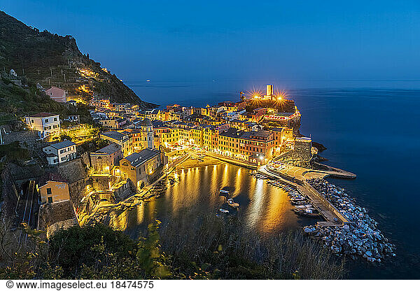 Italy  Liguria  Vernazza  Long exposure of illuminated coastal town along Cinque Terre at night