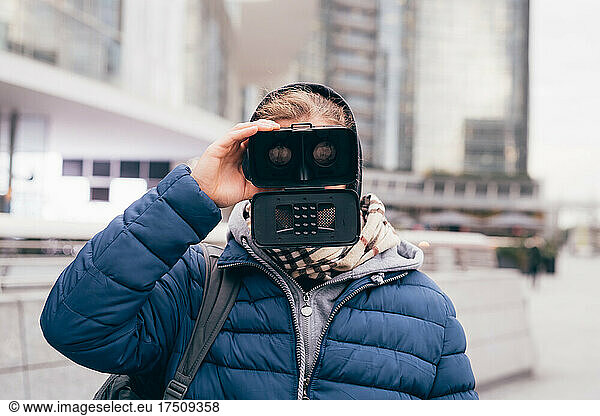 Italy  Man usingVRgoggles in city